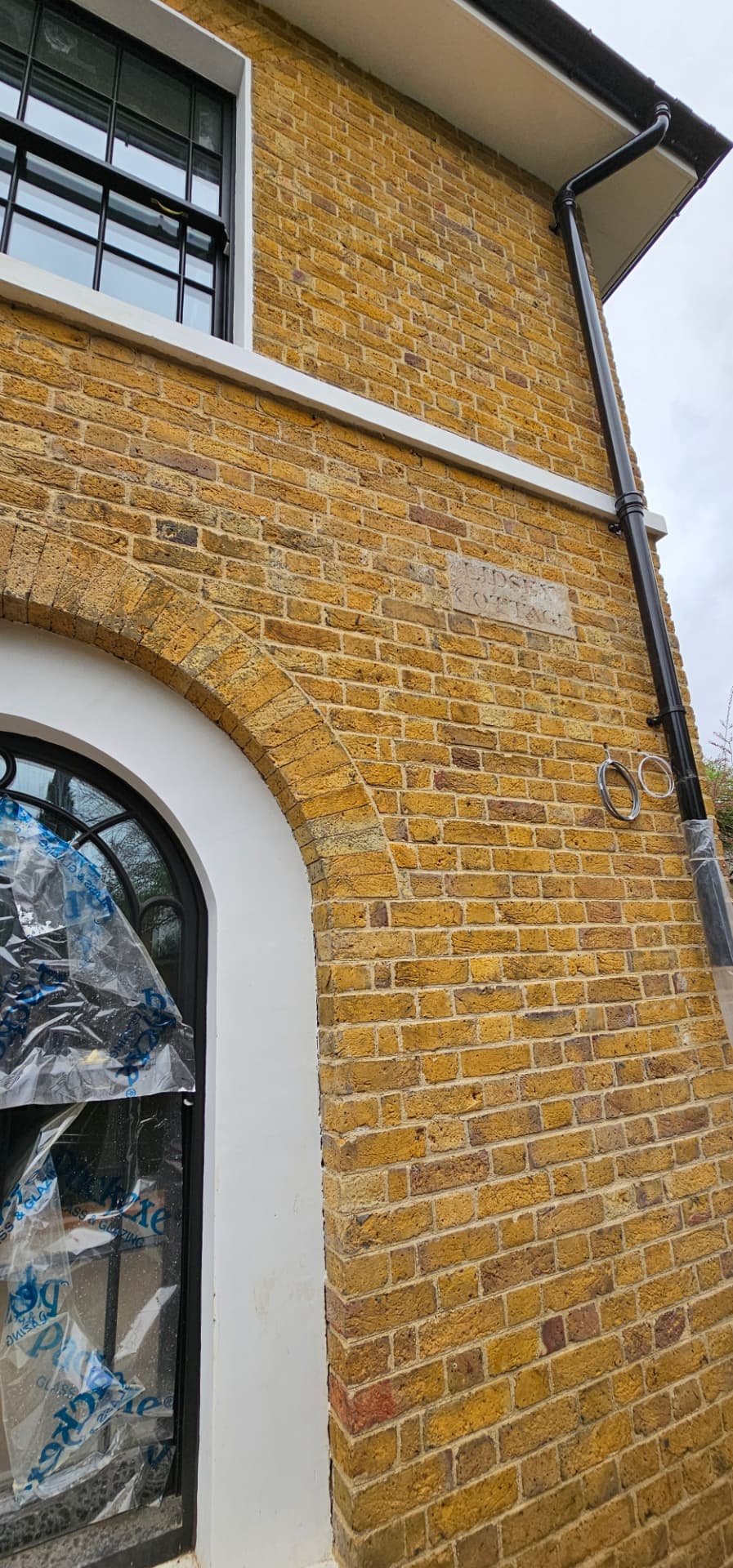 Brick arch and carved name stone at Bonnington Square, Vauxhall