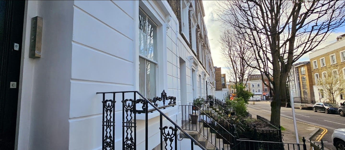 Finished white stucco frontage along the Islington terrace