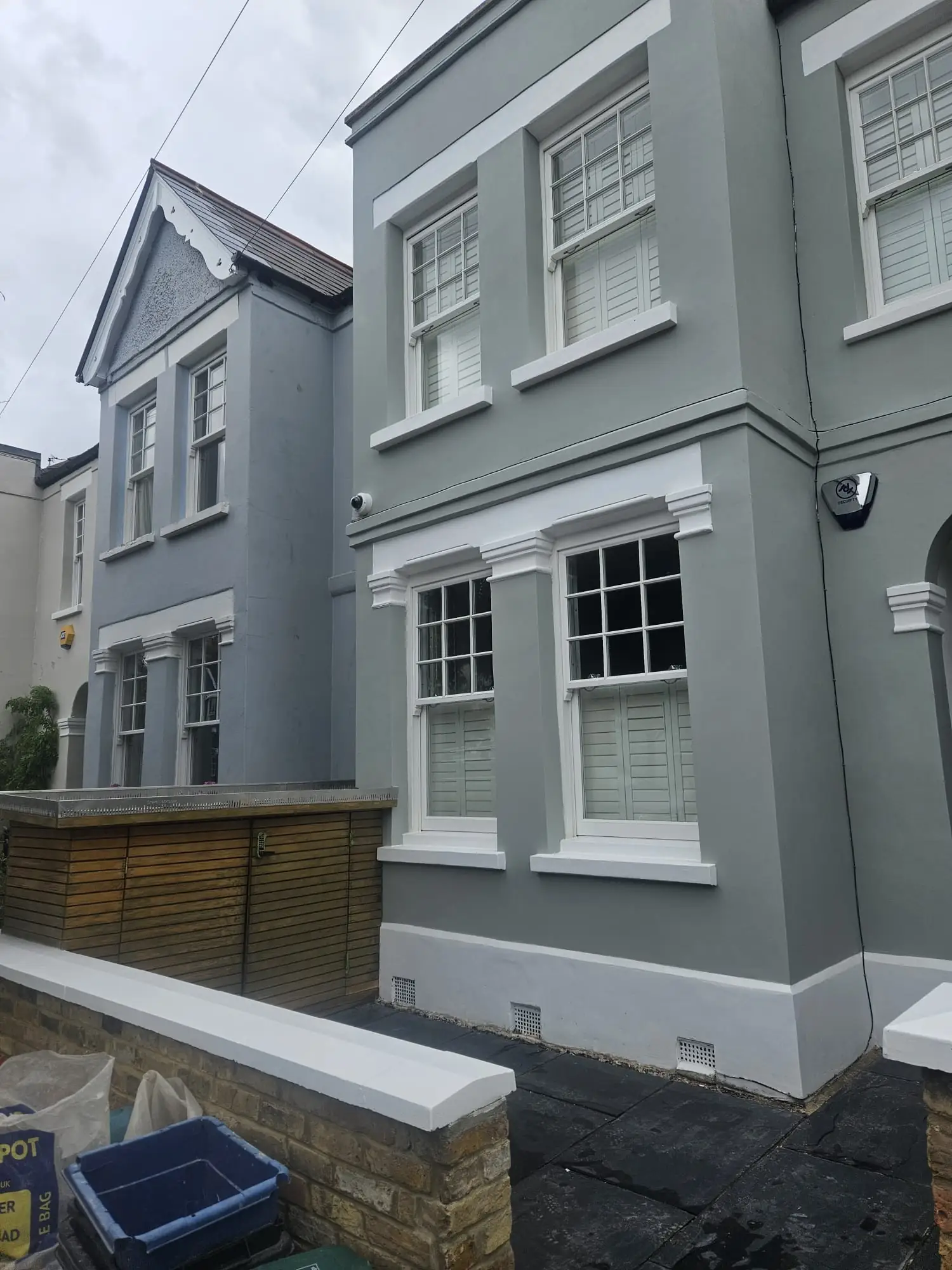 Restored render, mouldings and painted stonework to the side elevation at Wimbledon Village