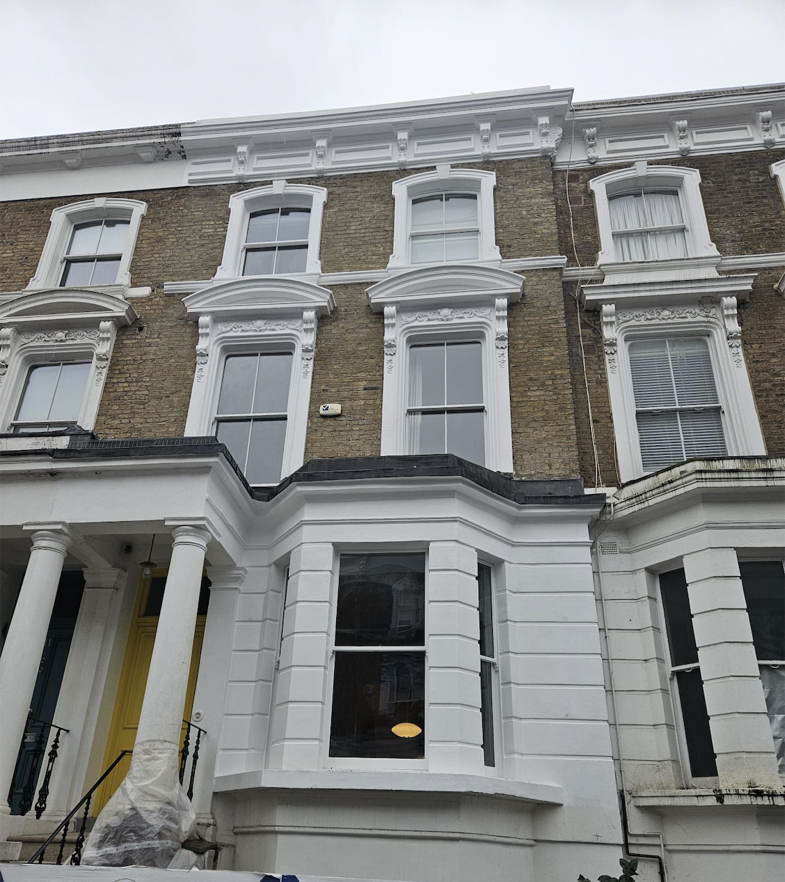 Repaired mouldings, cornice and window heads to the front elevation