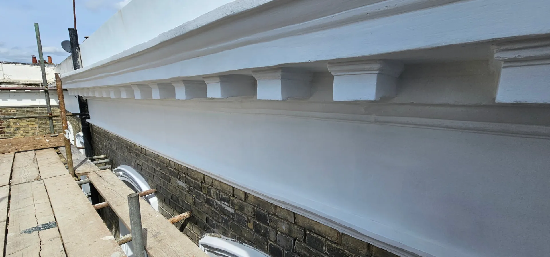 Re-formed modillion course and mouldings above the brickwork at Sunningdale Gardens