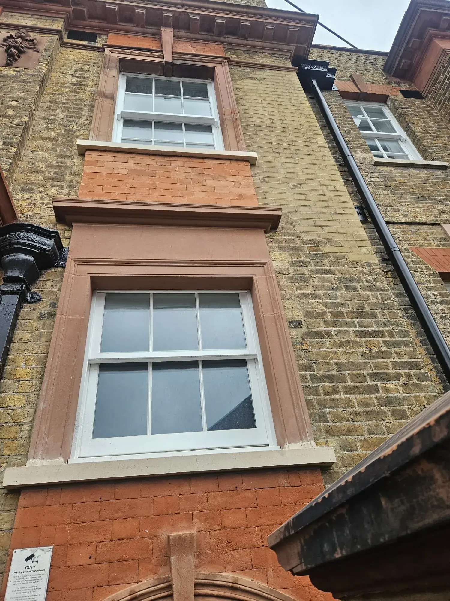 Sympathetic brick and stone repairs around the sash-window bays at Richmond Royal Hospital