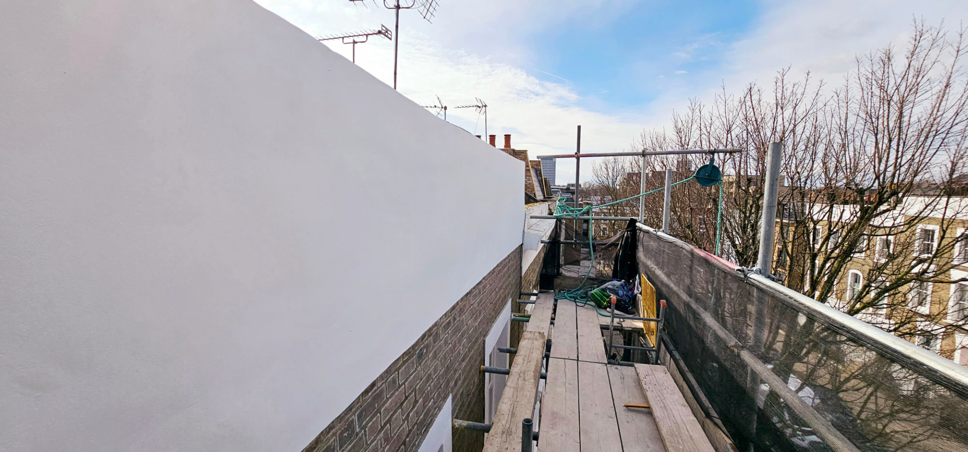 Scaffold view of the completed render to the upper elevation