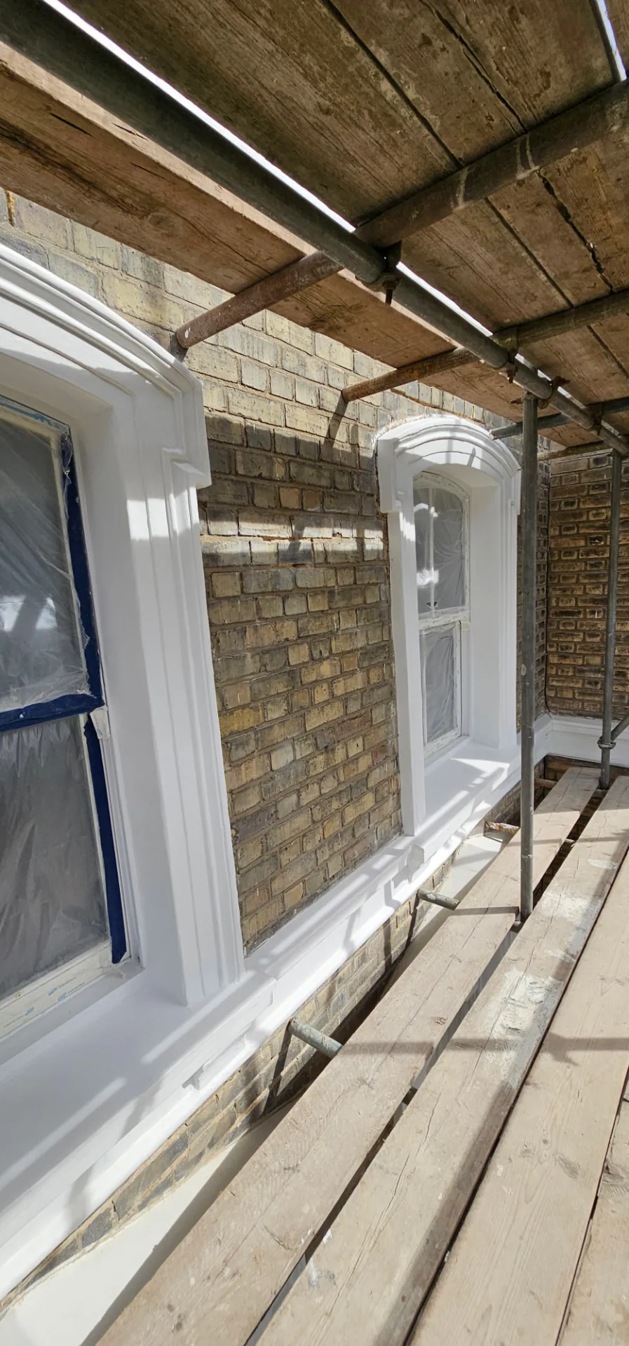Restored stucco window surrounds and architraves at Sunningdale Gardens, Kensington